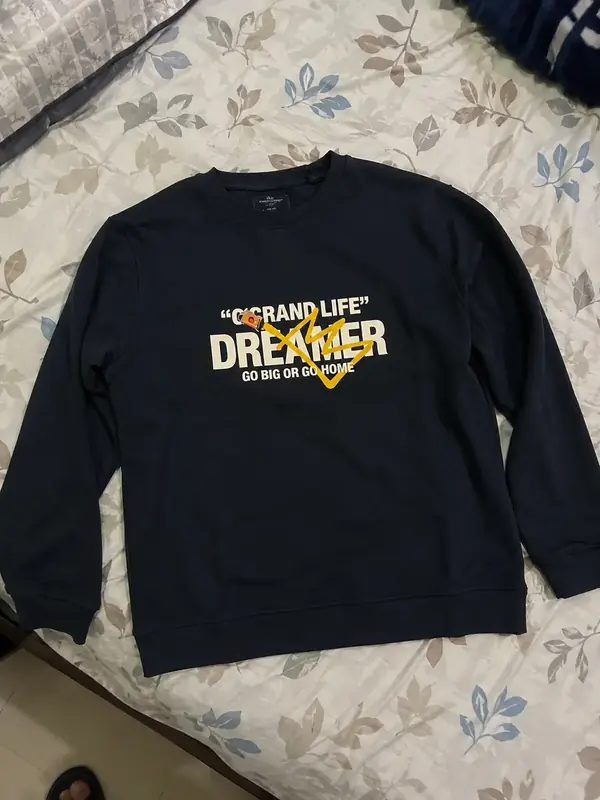 Customer's sweatshirt lying on a bed